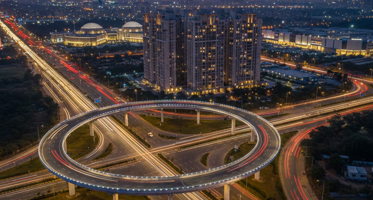 A stunning aerial shot of the VD Junction flyover in Ahmedabad,
showcasing its connectivity and the high-rise residential buildings of
Malabar Retreat at Vaishnodevi Circle at sunset.